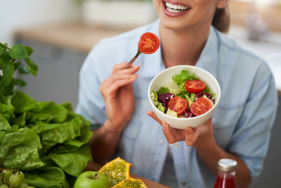 happy woman enjoying healthy food after dental implants